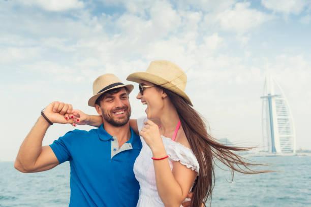 A happy couple enjoys a day by the sea near Park Beach Residence, hinting at leisure facilities available.